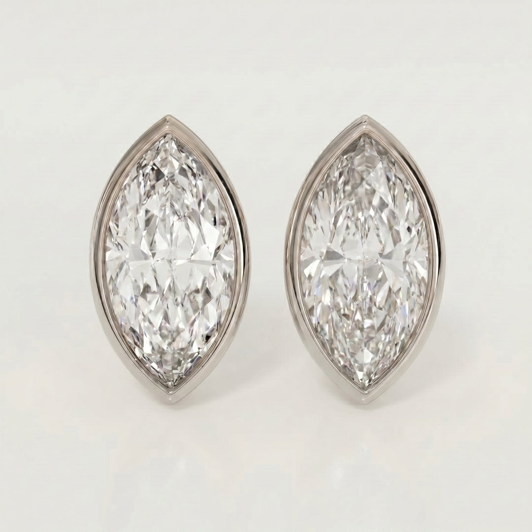 Pair of diamond earrings on a light gray background