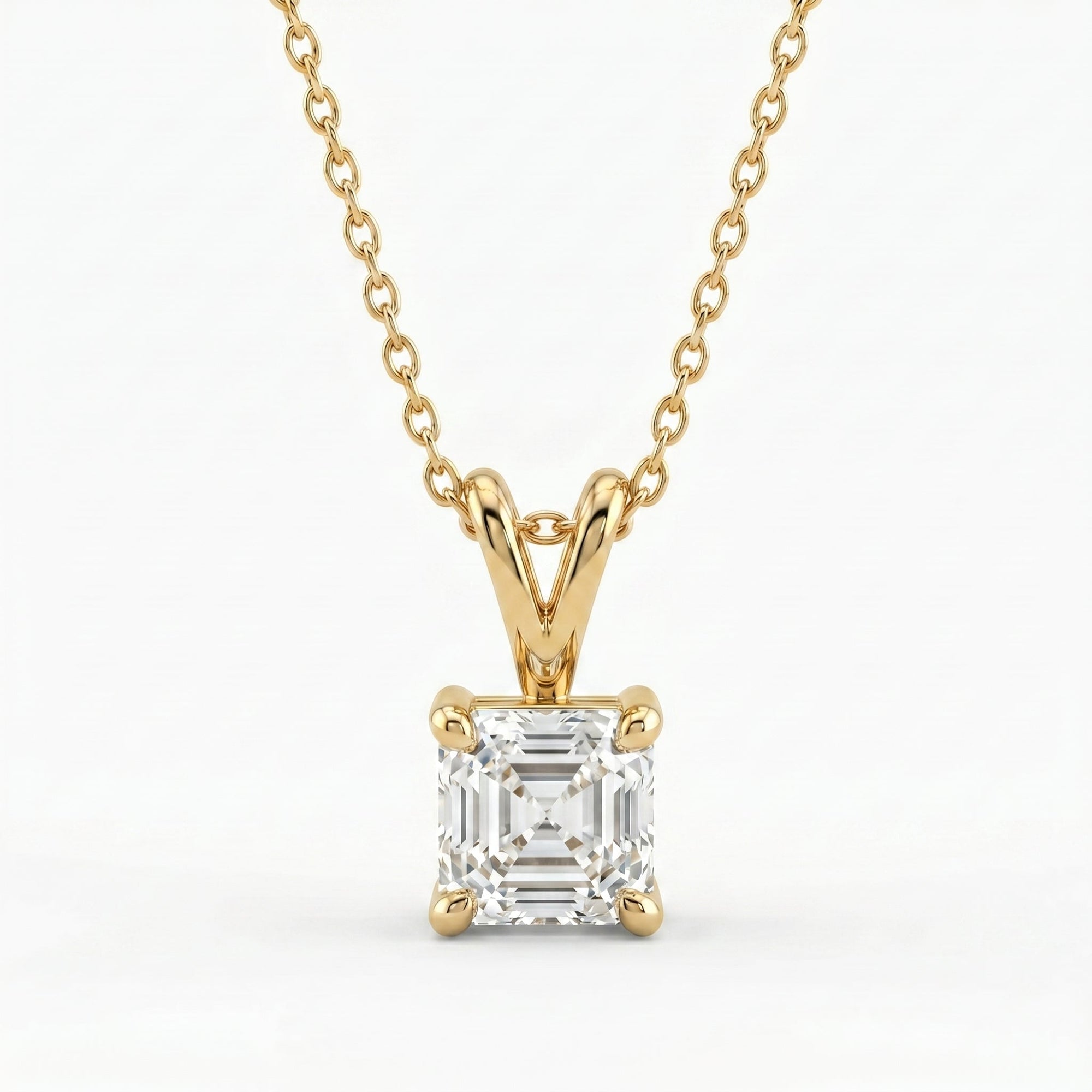 Gold necklace with a diamond pendant on a white background