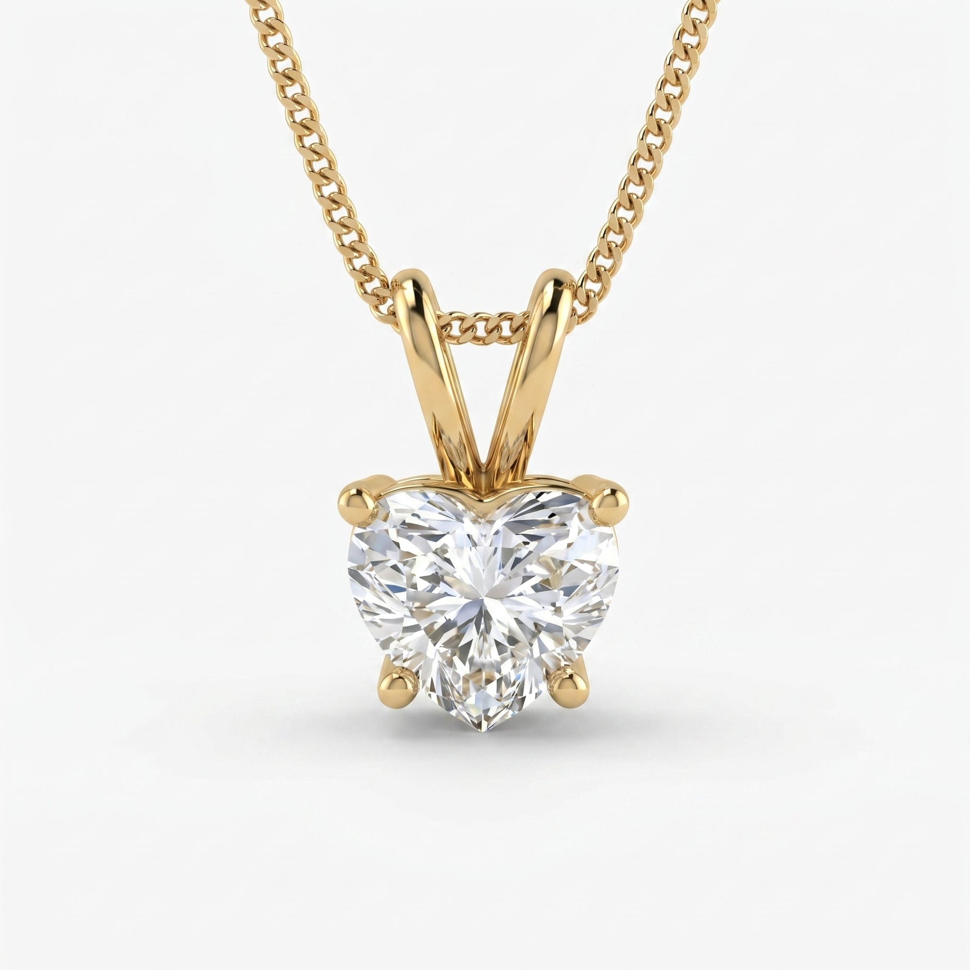 Gold necklace with a heart-shaped diamond pendant on a white background