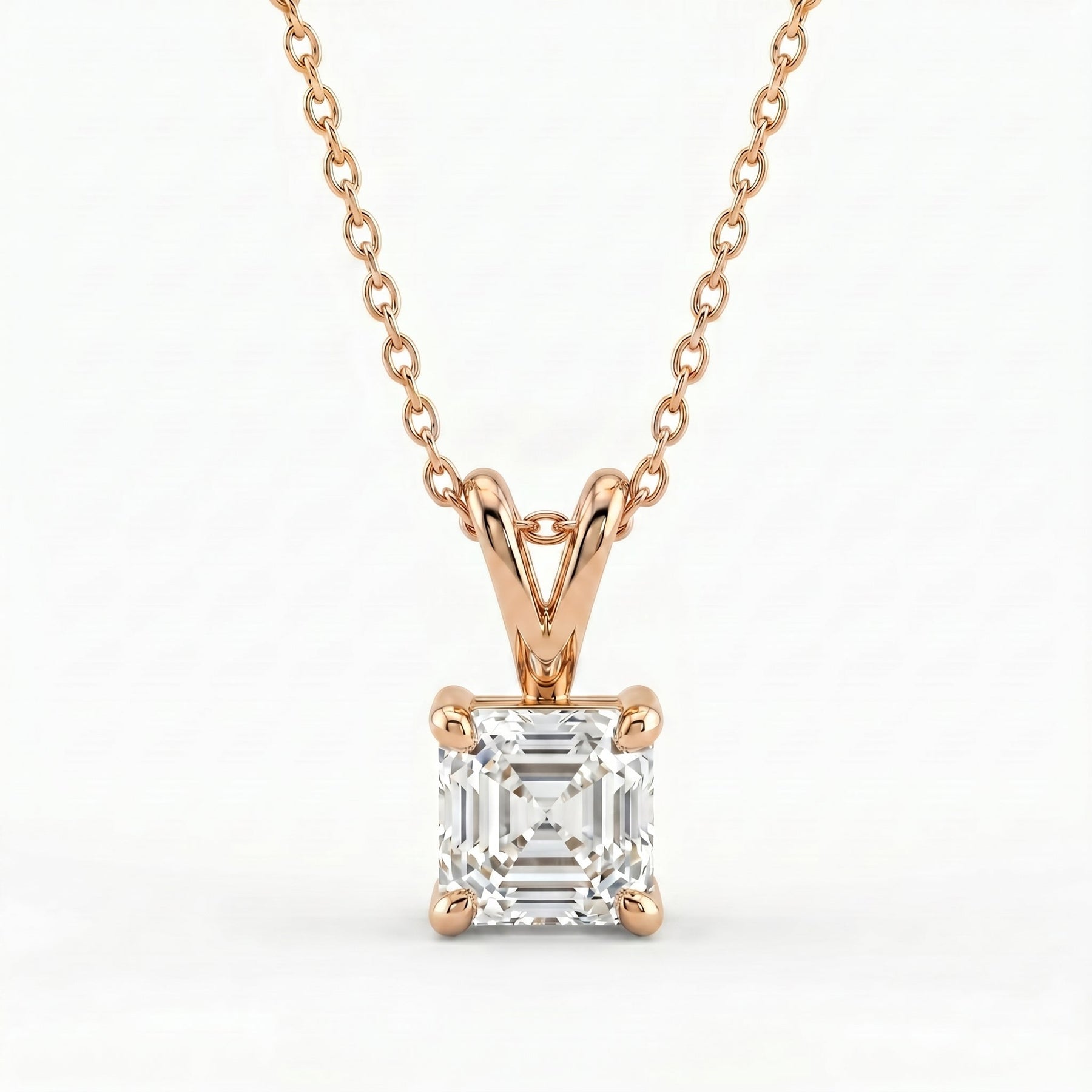 Rose gold necklace with a diamond pendant on a white background