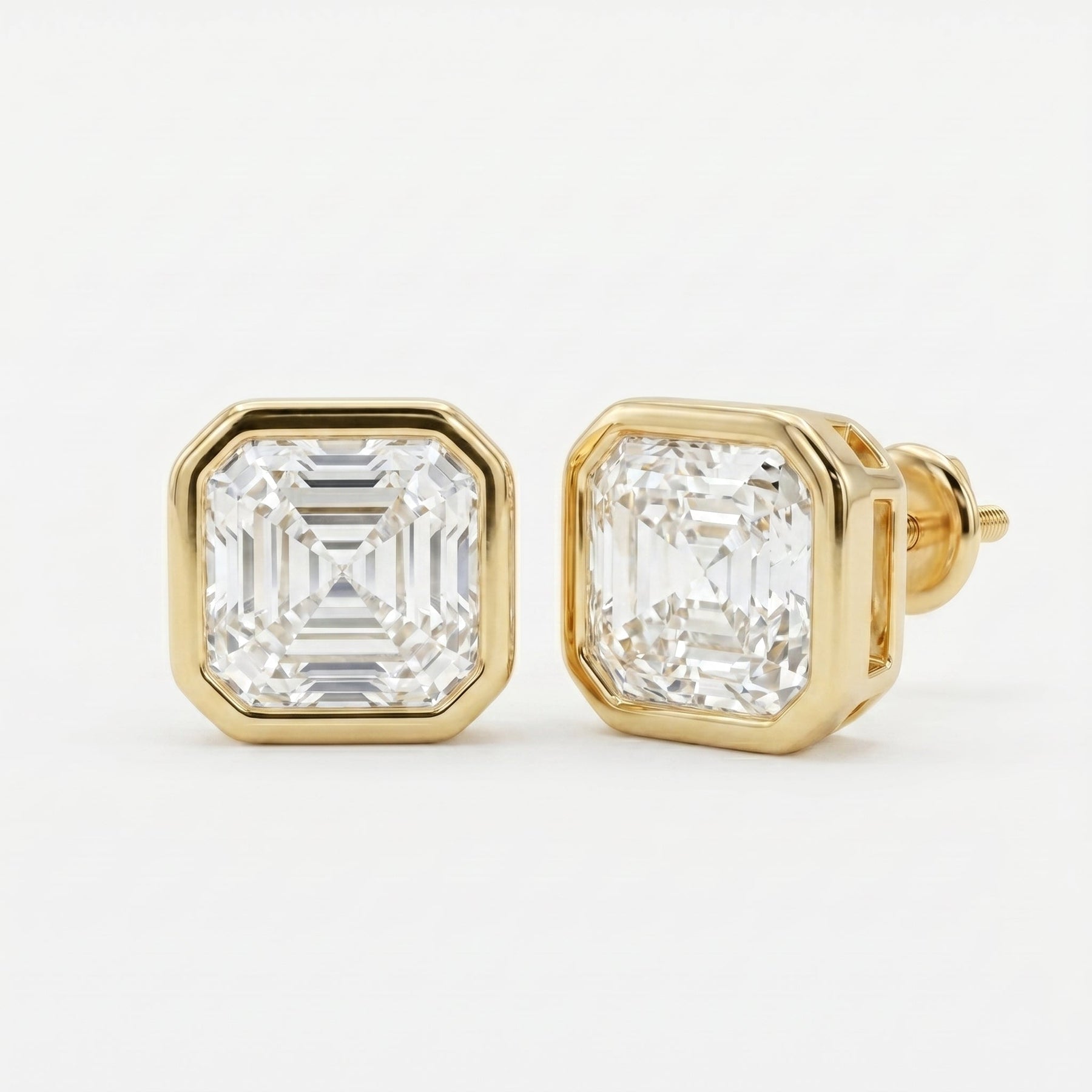 Gold earrings with Ascher-cut diamonds on a white background