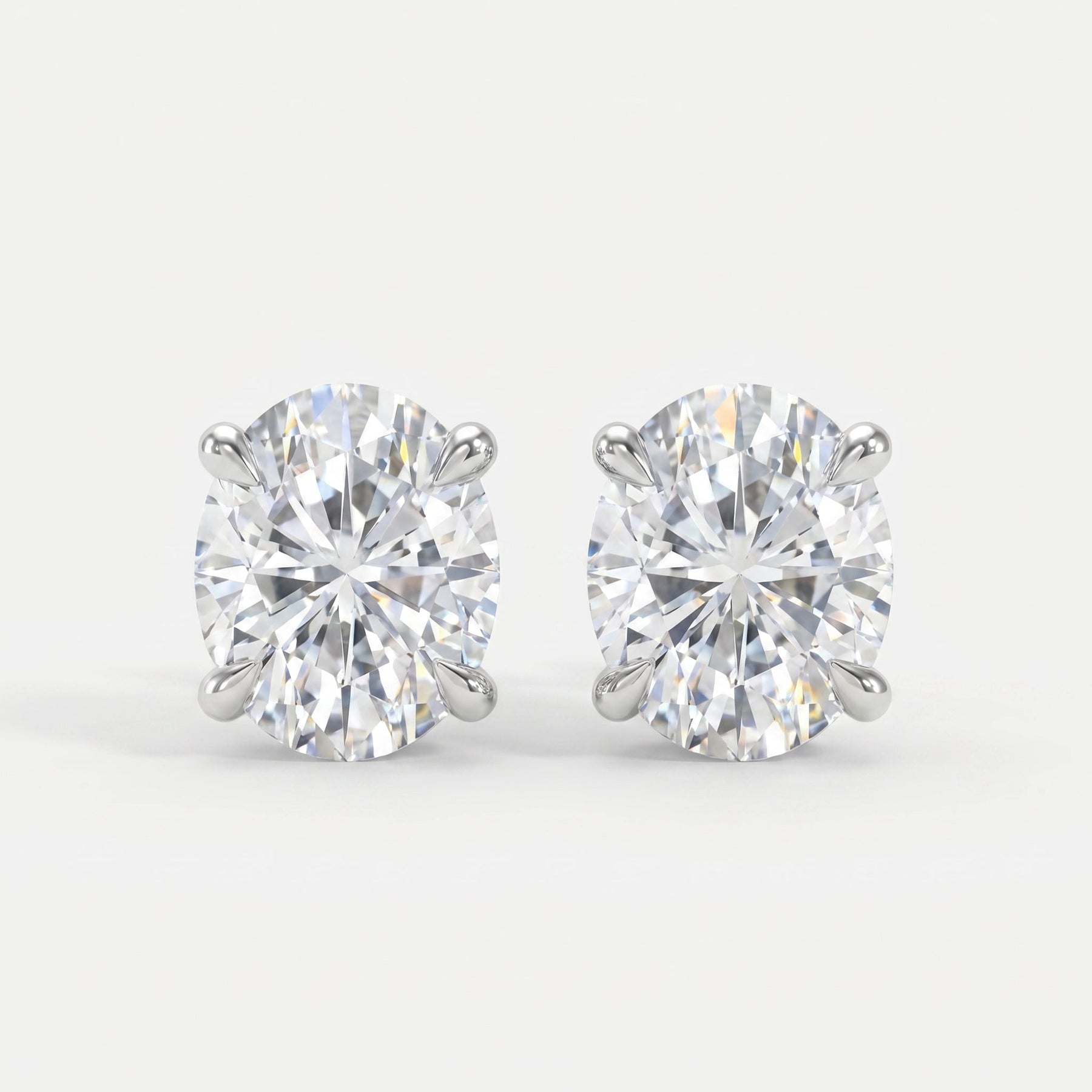 Pair of diamond stud earrings on a light gray background