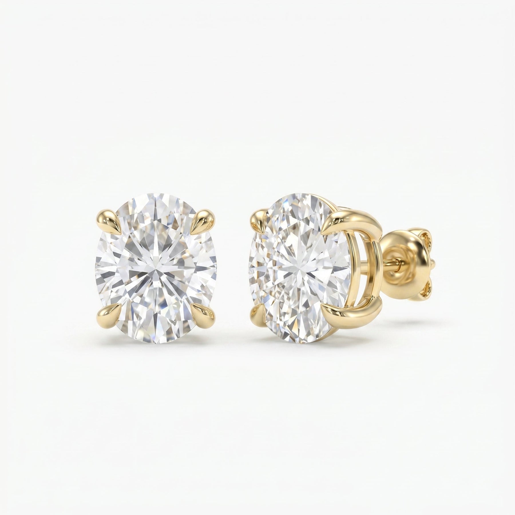 Gold earrings with clear gemstones on a white background