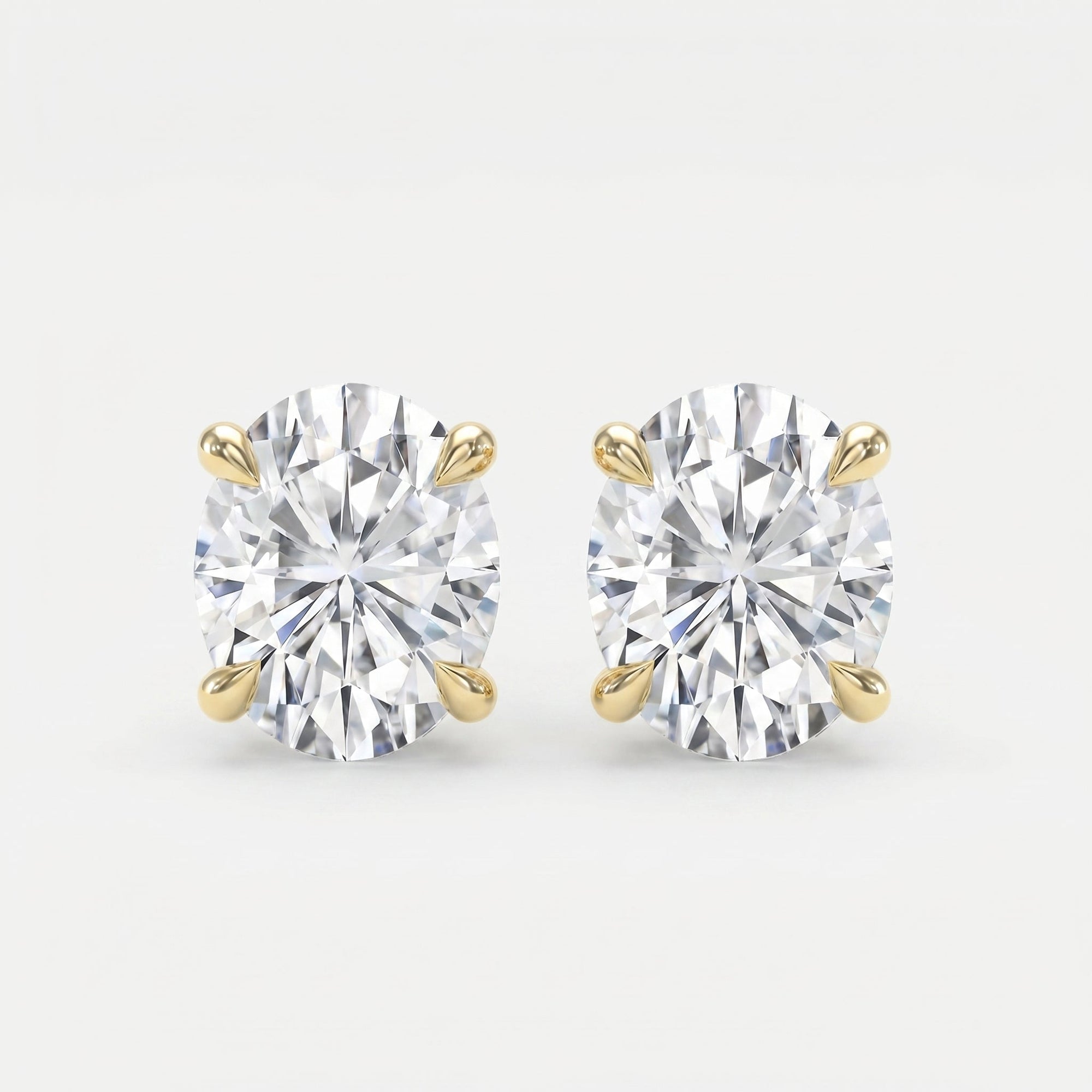 Pair of diamond stud earrings on a light gray background