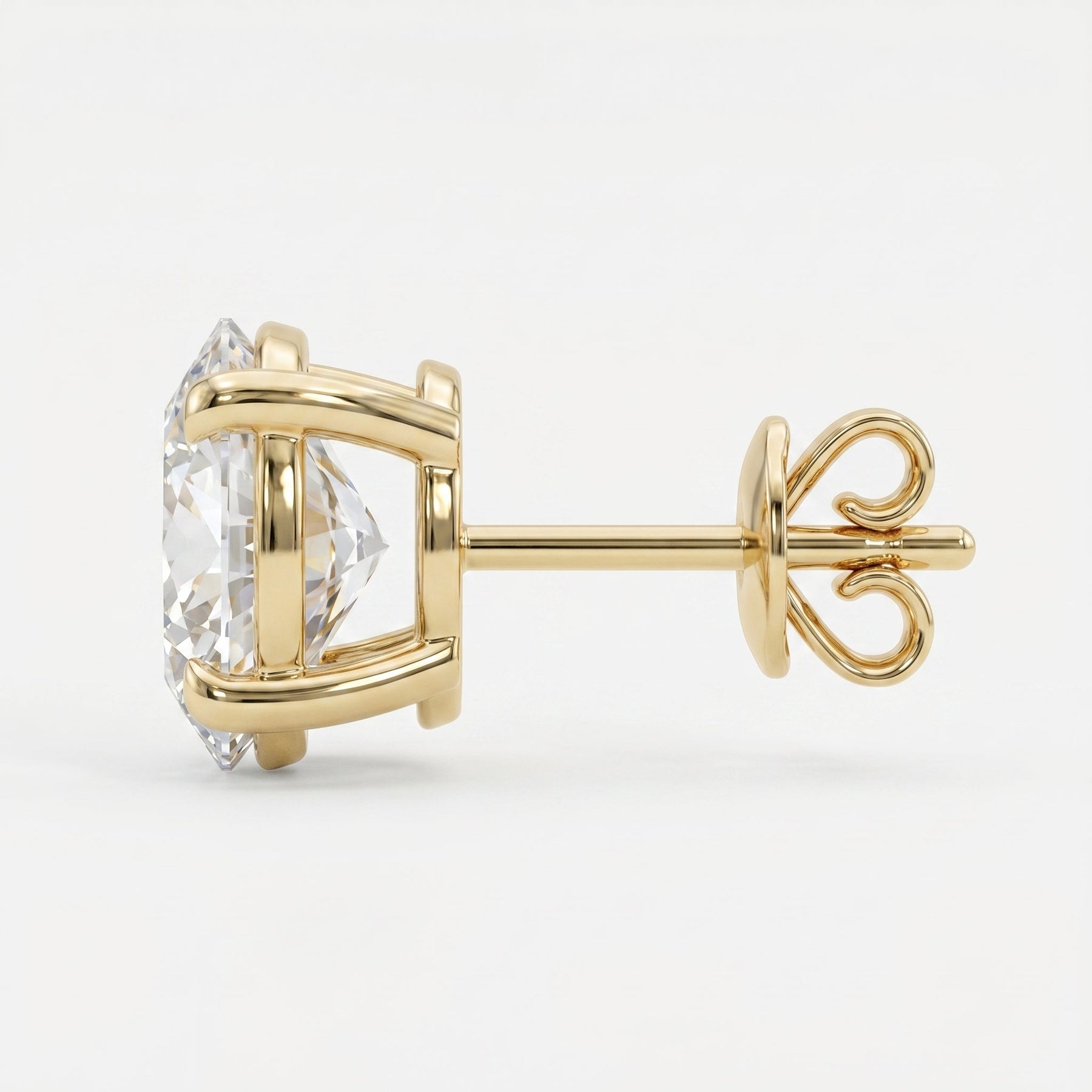 Gold earring with a clear gemstone on a white background