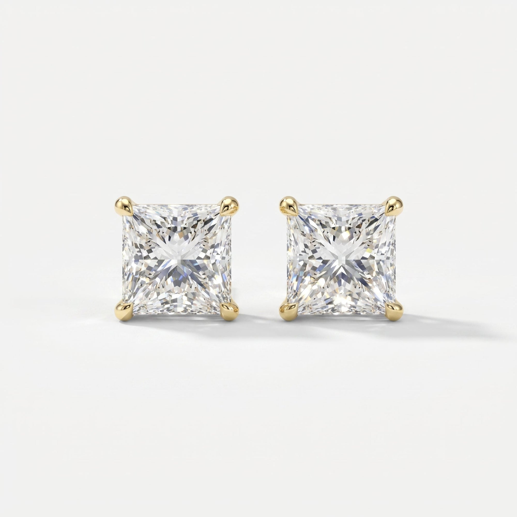 Pair of diamond stud earrings on a light gray background