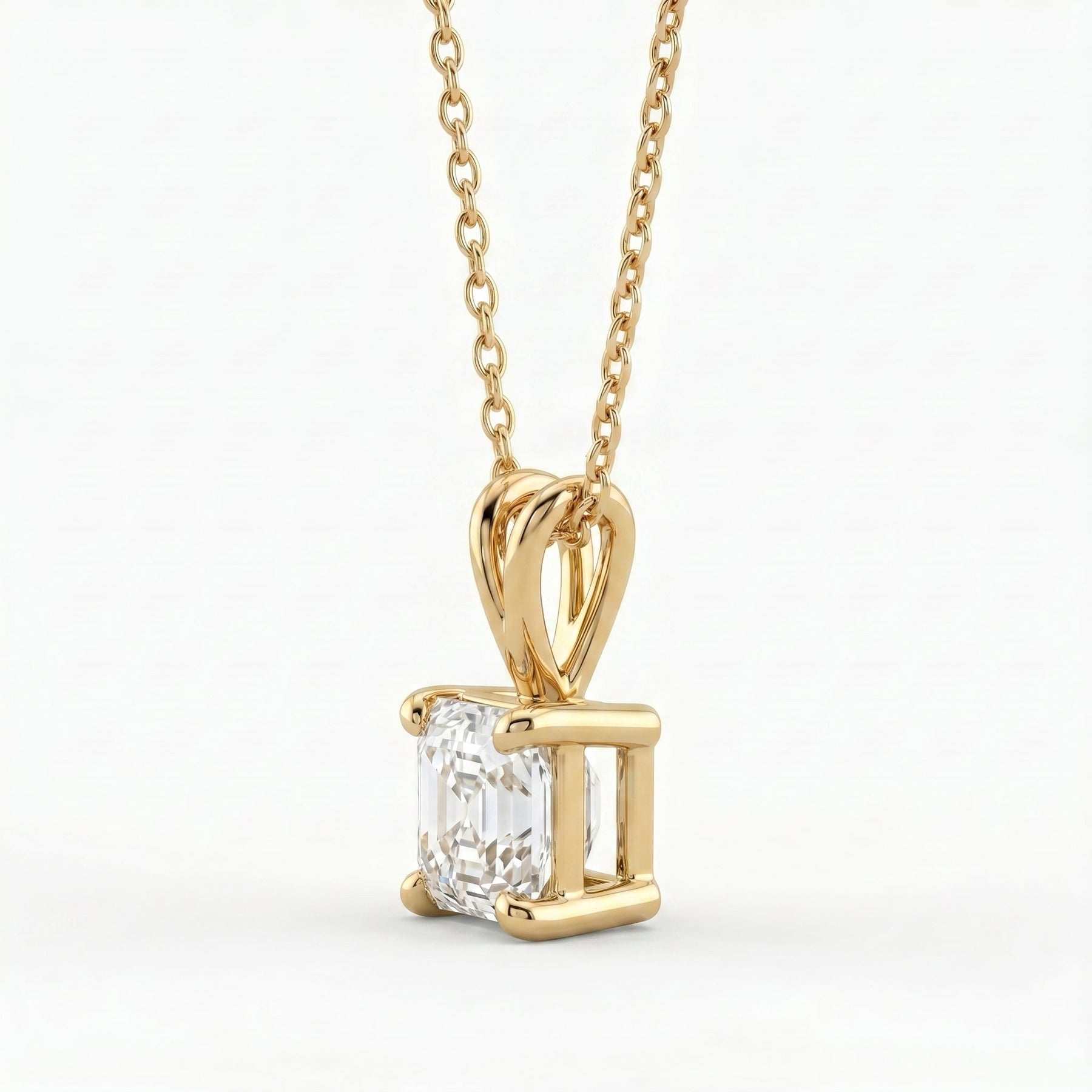 Gold pendant with a diamond on a white background