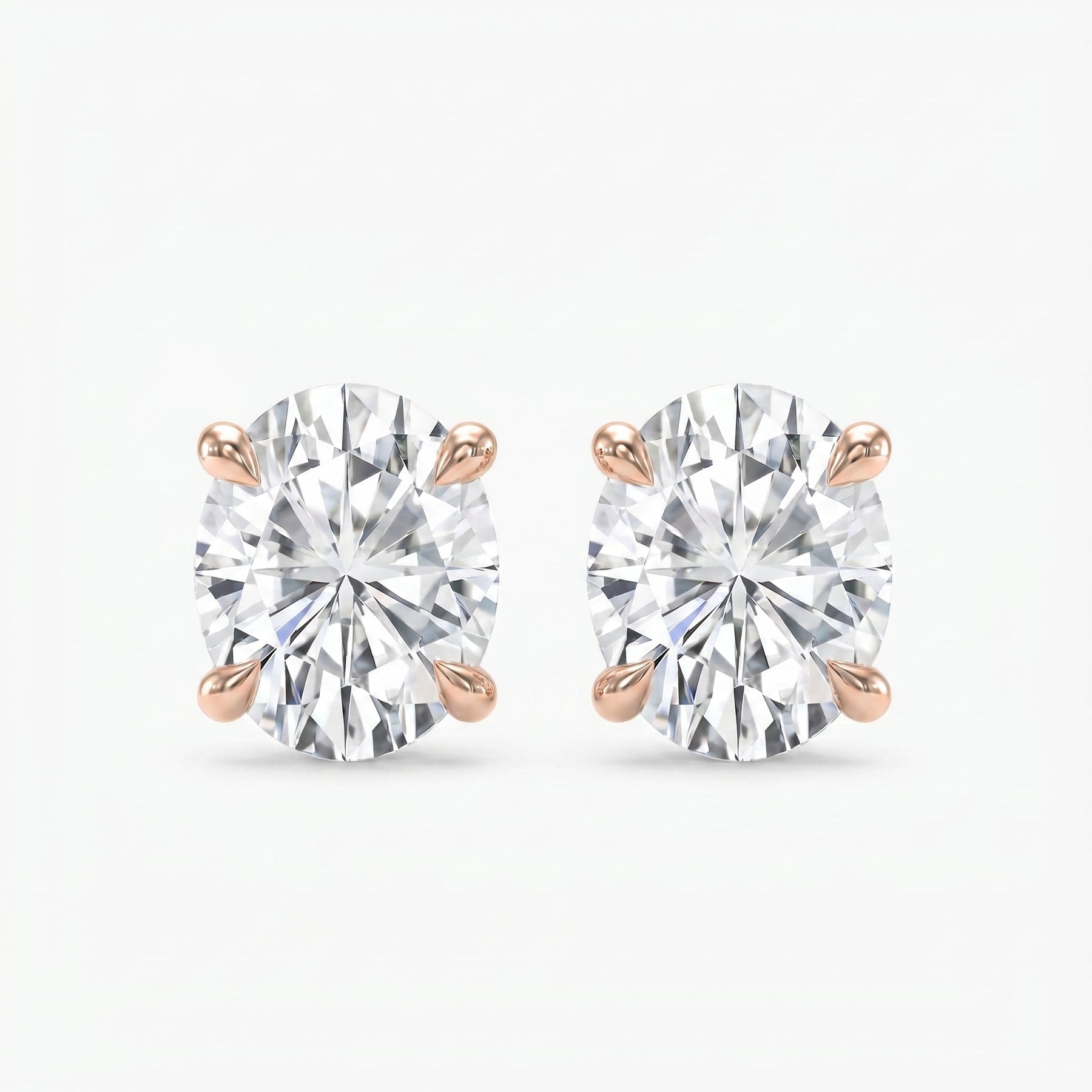 Pair of diamond stud earrings on a white background