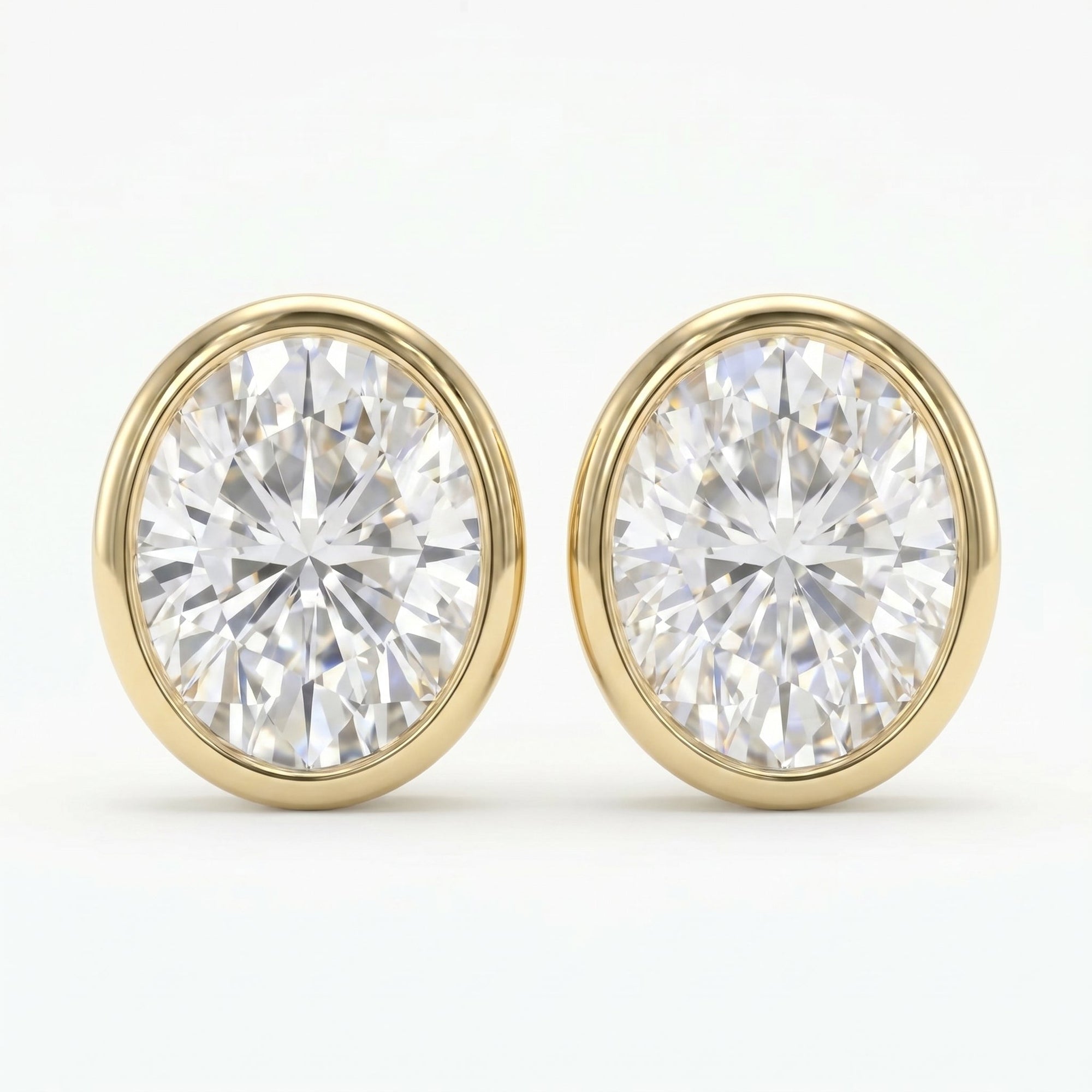 Pair of diamond stud earrings with gold rims on a white background