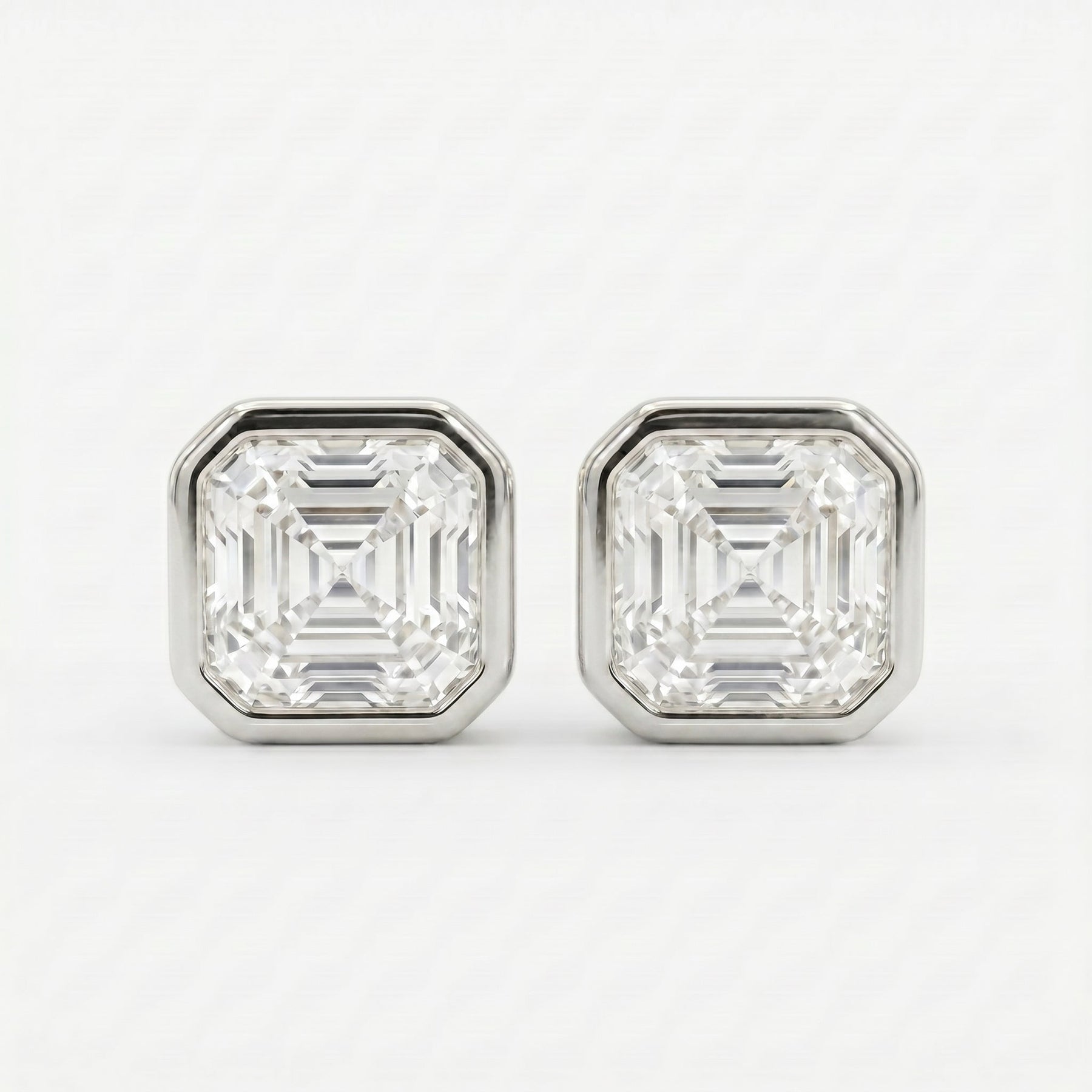 Pair of diamond stud earrings on a white background
