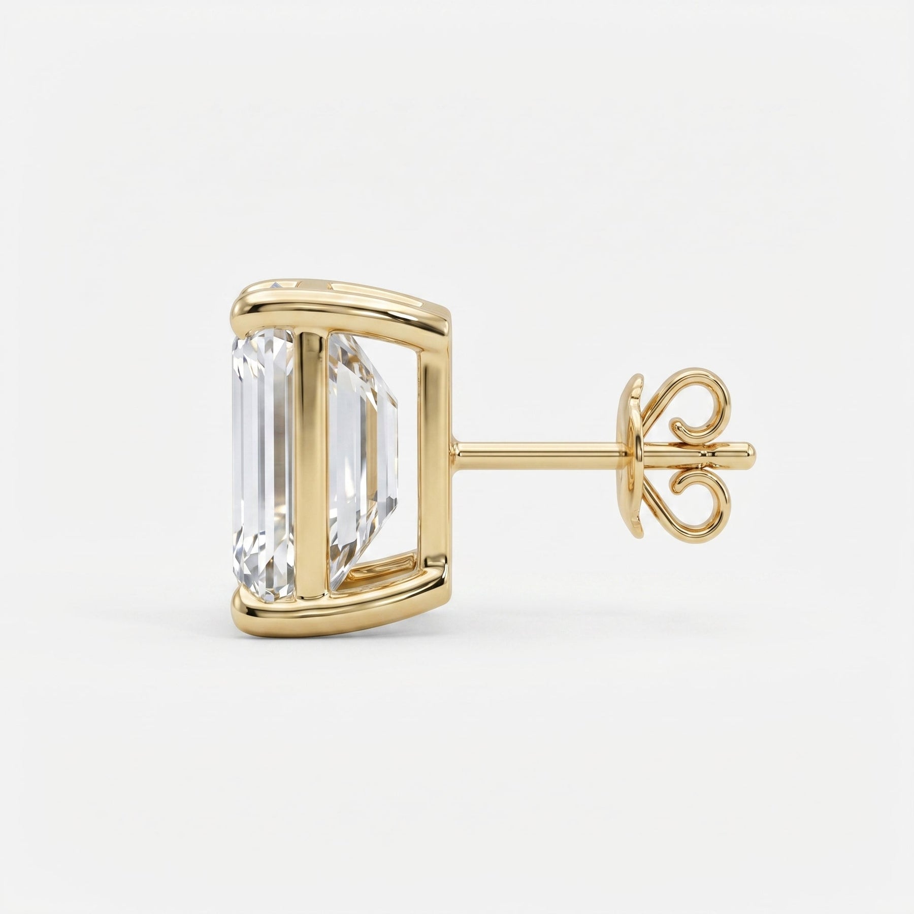 Gold earring with a large clear gemstone on a white background