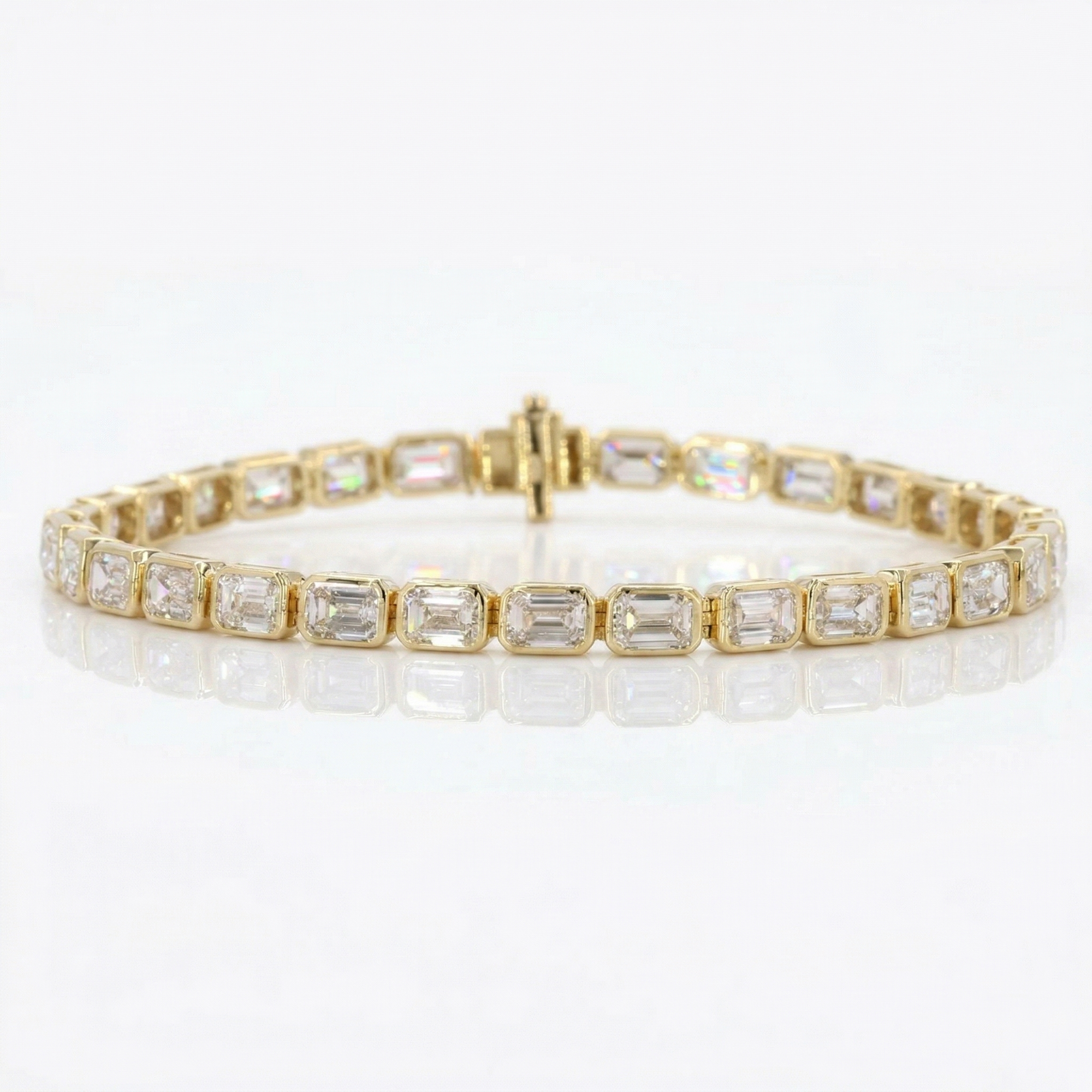 Gold bracelet with emerald-cut diamonds on a white background