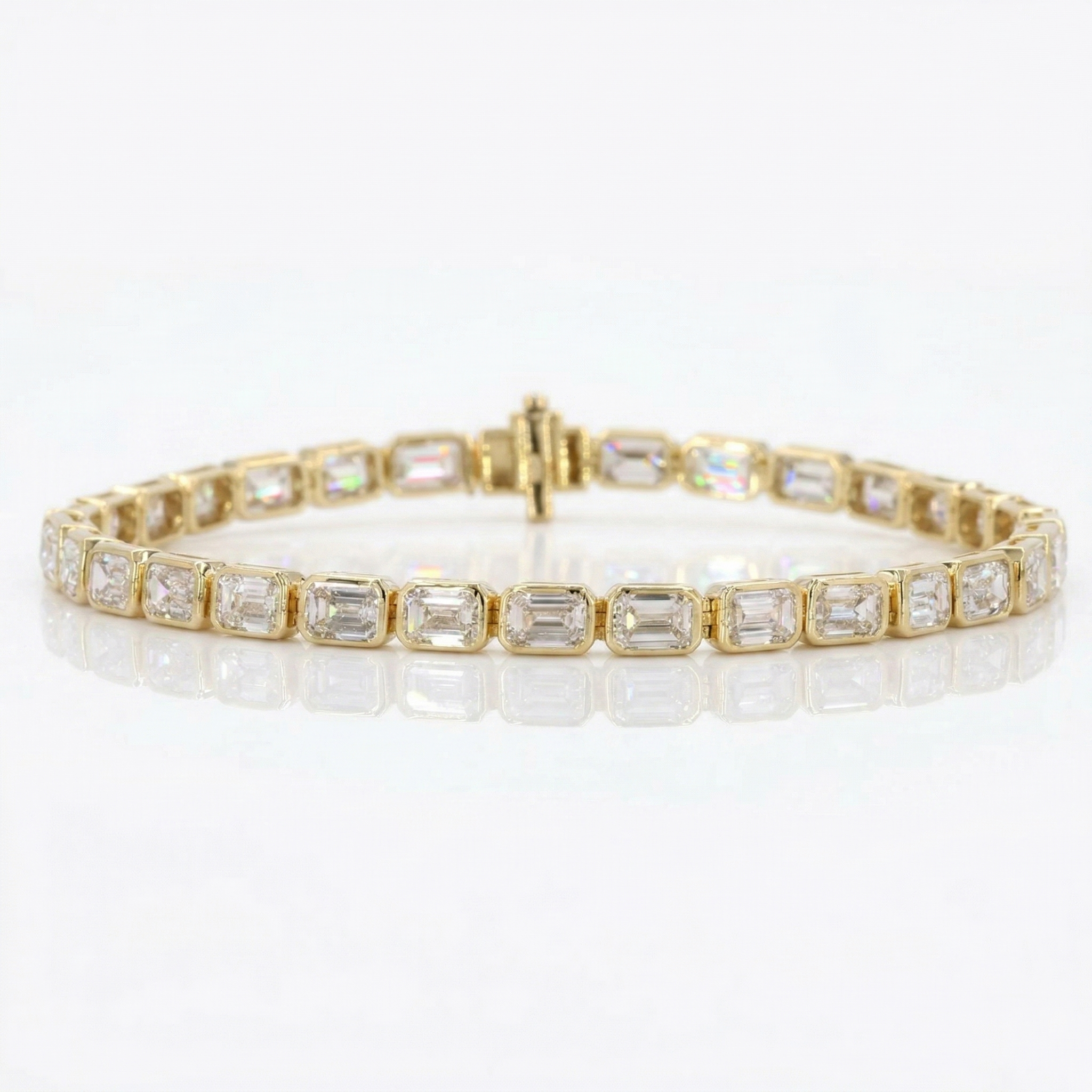 Gold bracelet with emerald-cut diamonds on a white background