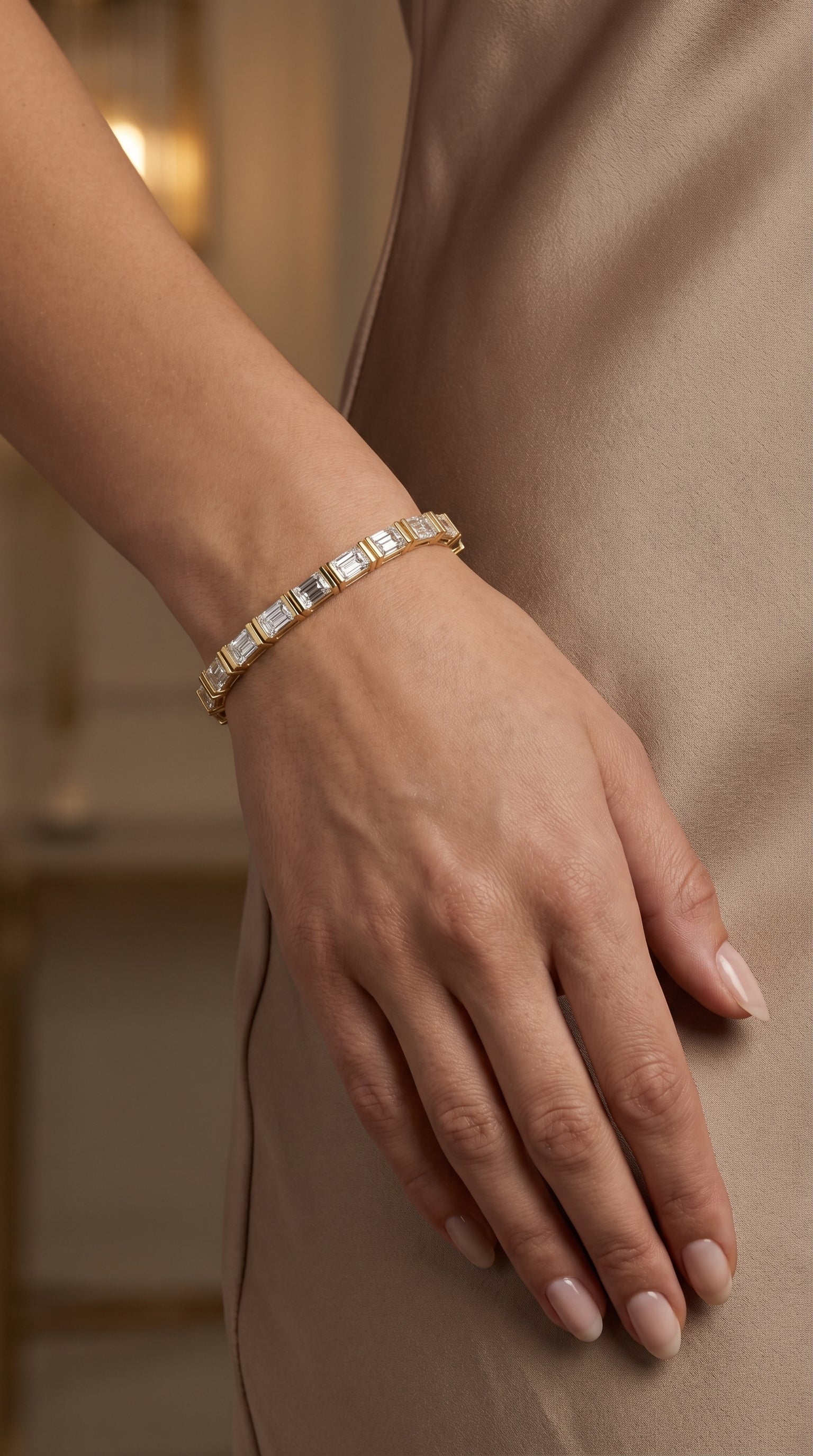 Hand wearing a diamond bracelet on a blurred background