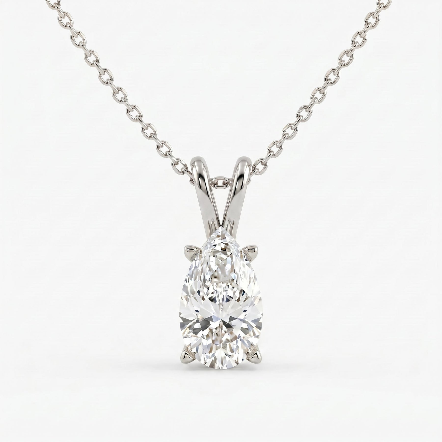Diamond pendant on a chain against a white background