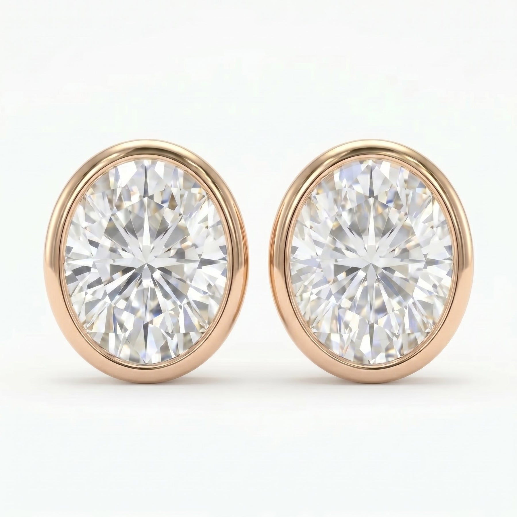 Pair of diamond stud earrings with rose gold settings on a white background
