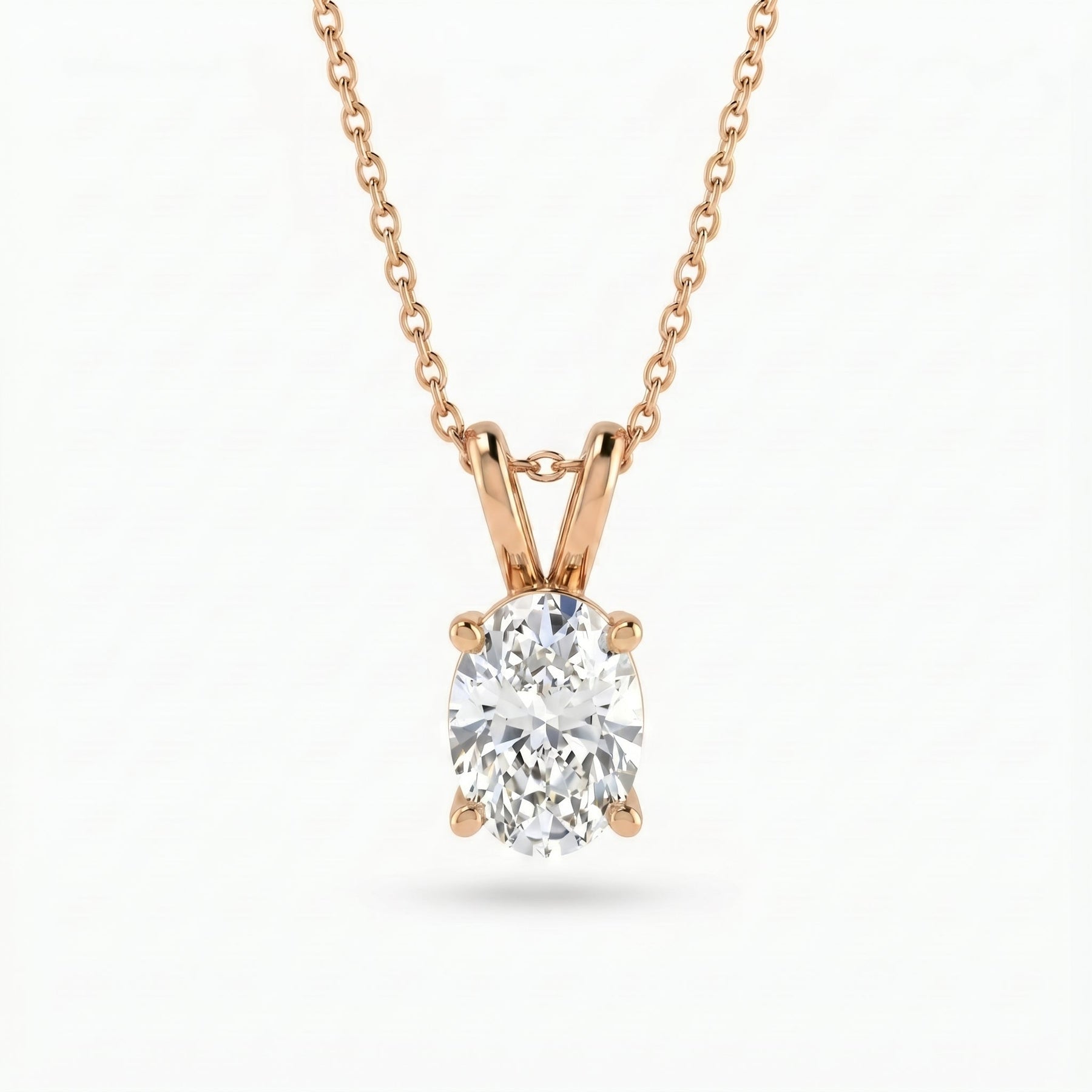 Rose gold necklace with a diamond pendant on a white background