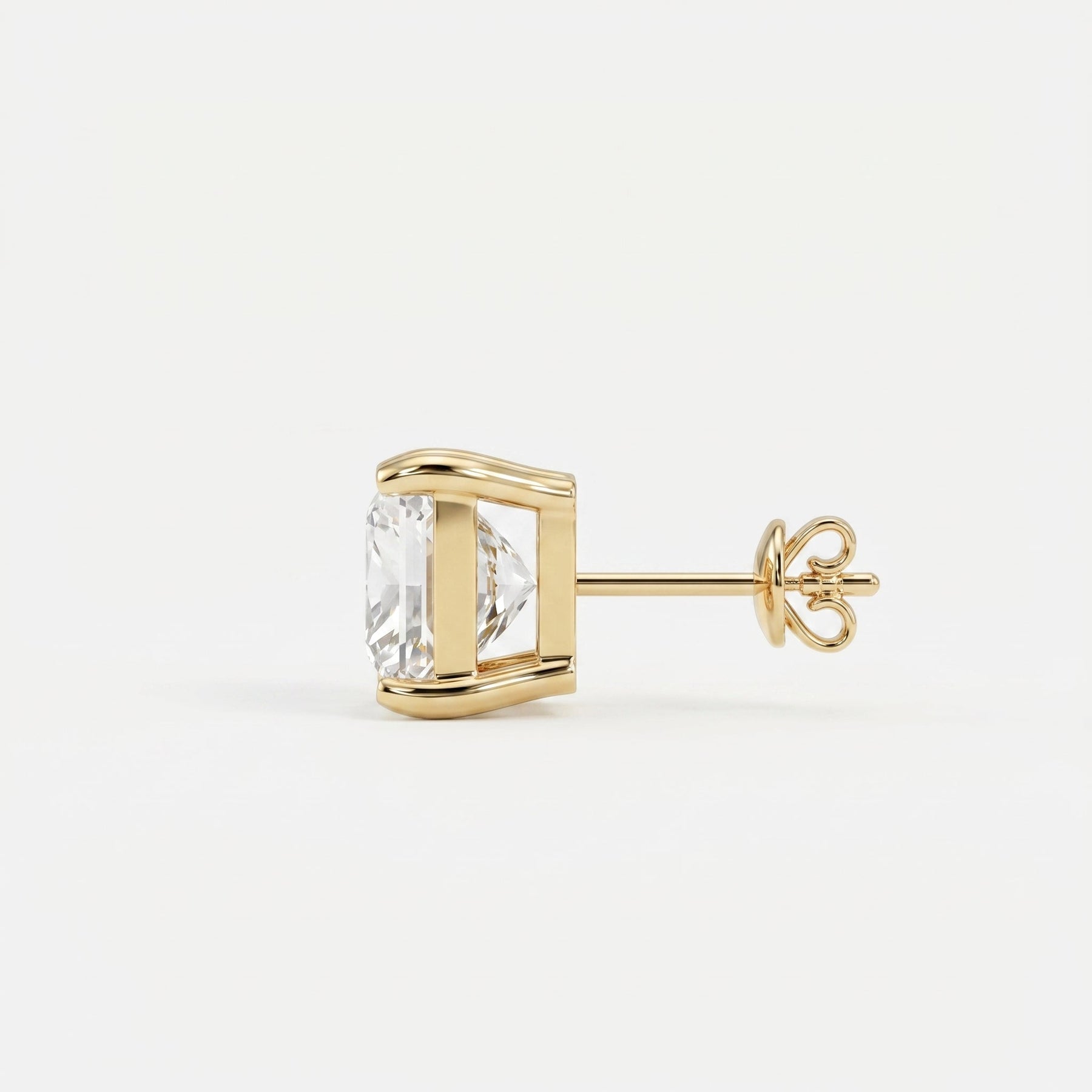 Gold earring with a clear gemstone on a white background