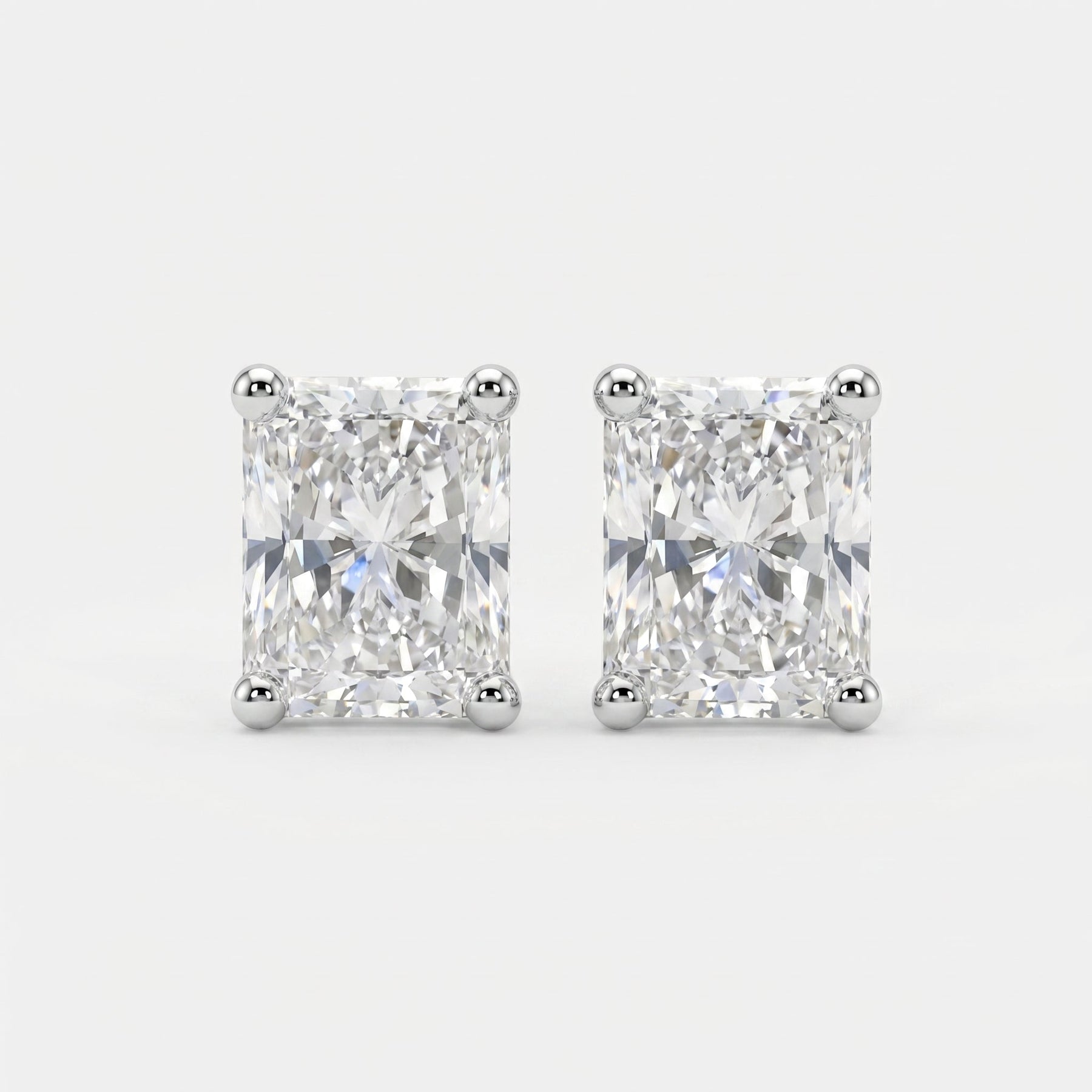 Pair of diamond stud earrings on a light gray background