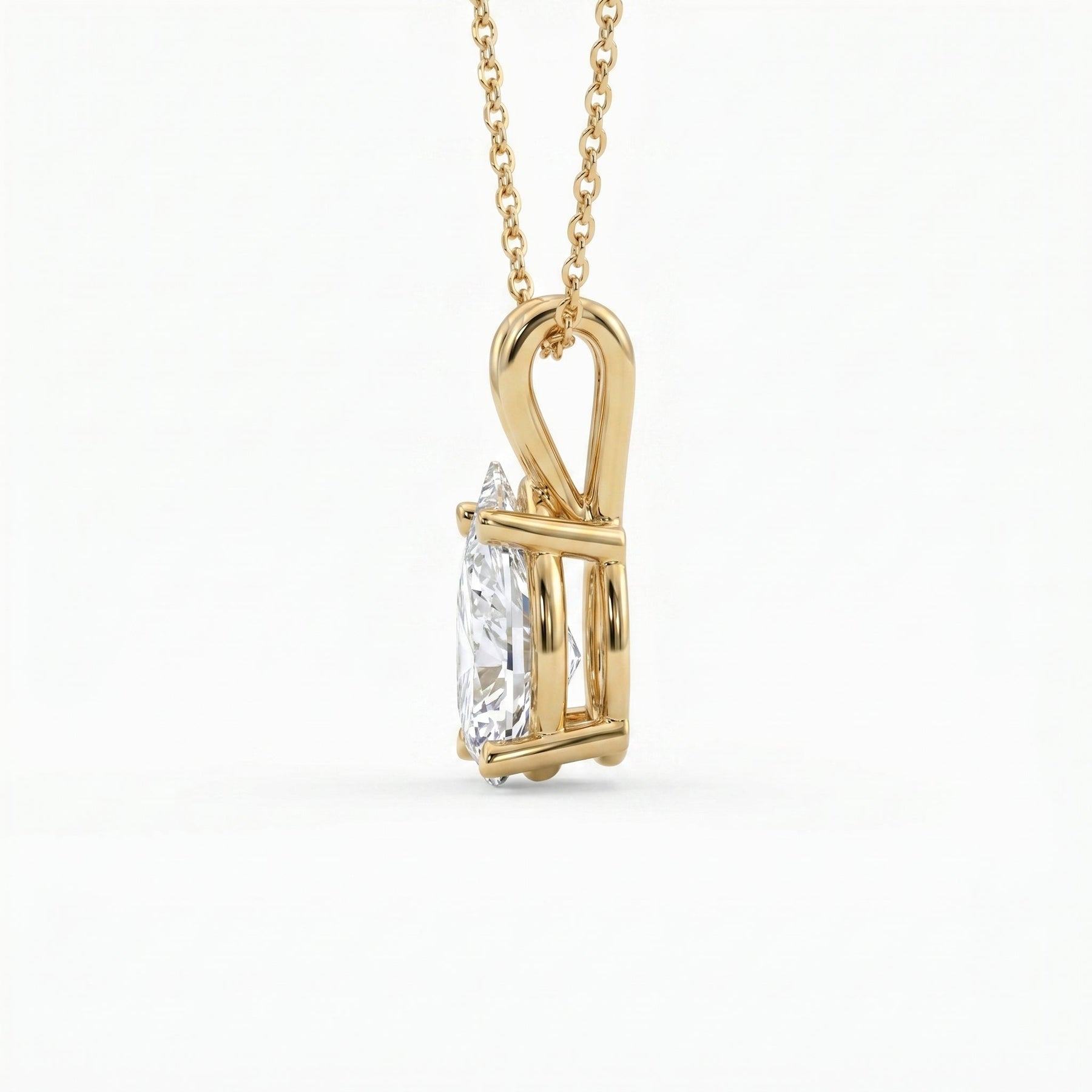 Gold pendant with a diamond on a white background