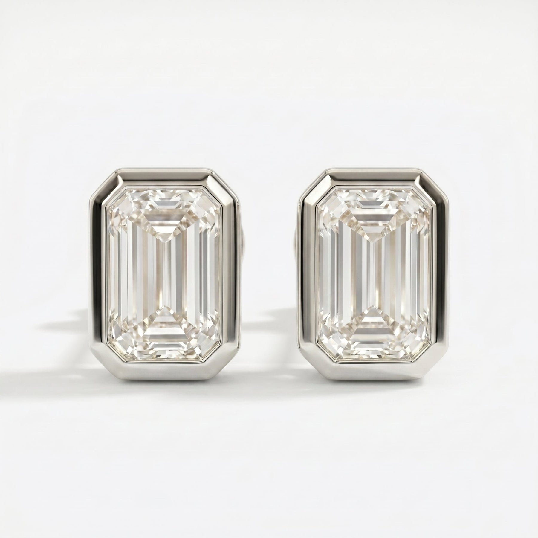 Pair of diamond stud earrings on a white background