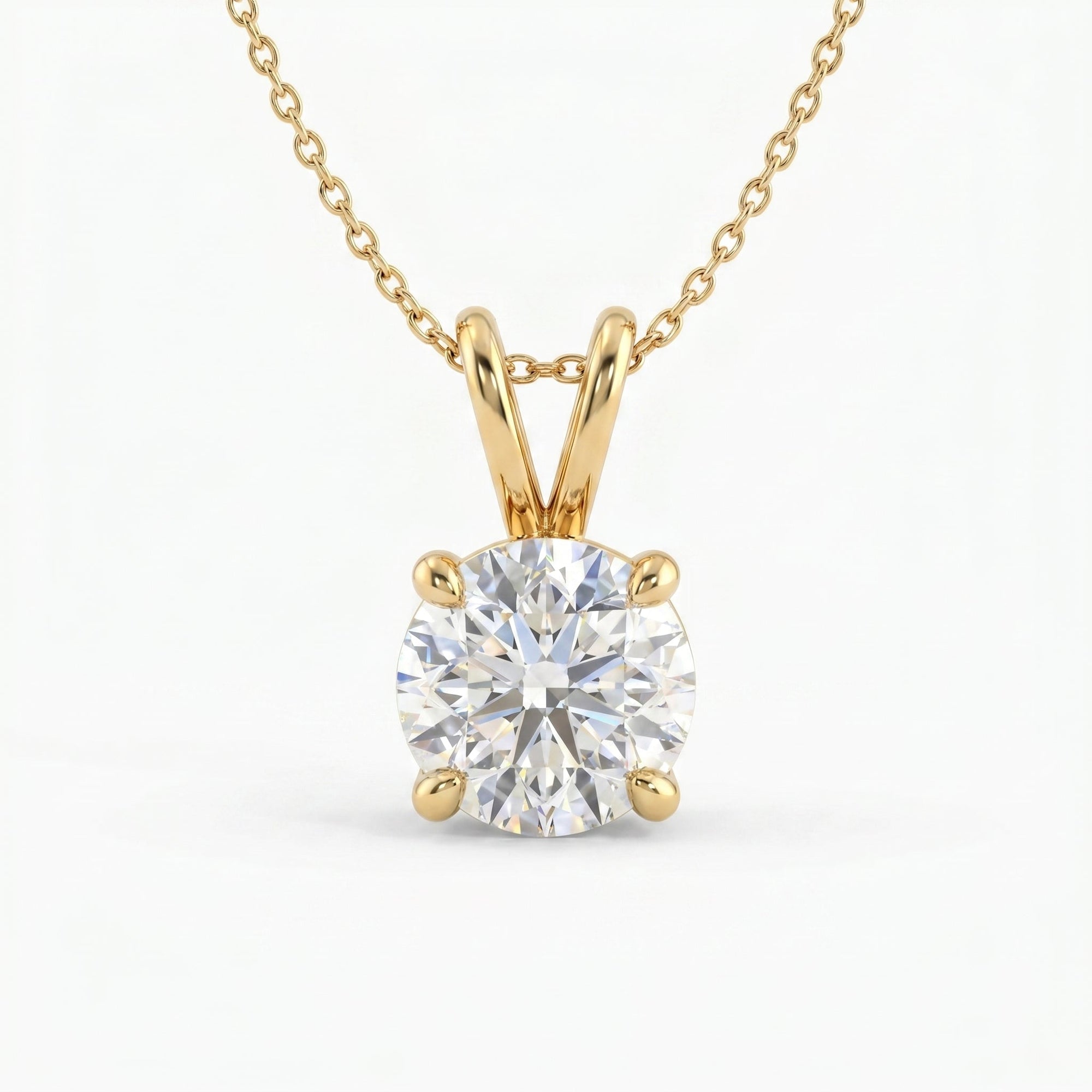 Gold necklace with a round diamond pendant on a white background