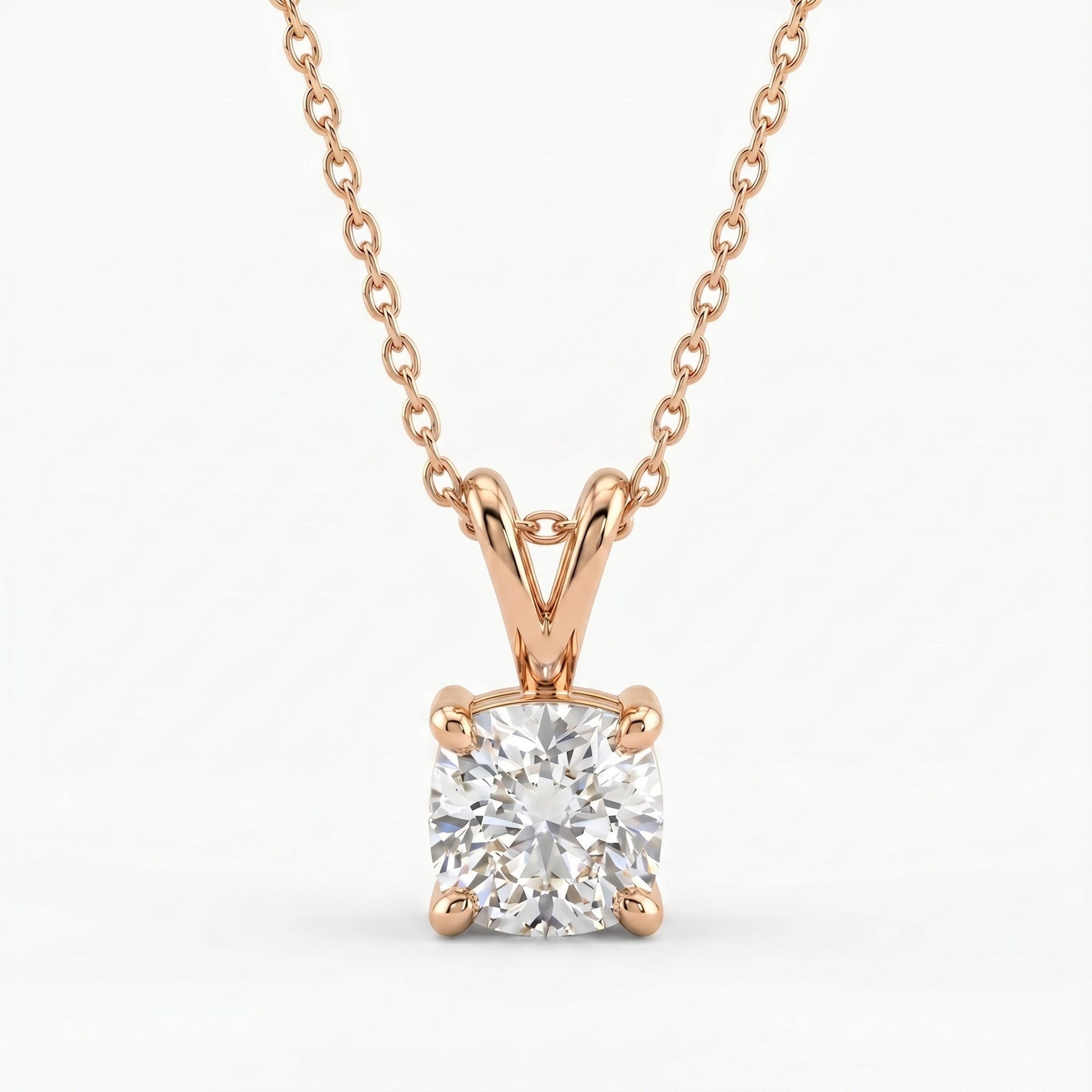 Rose gold necklace with a diamond pendant on a white background