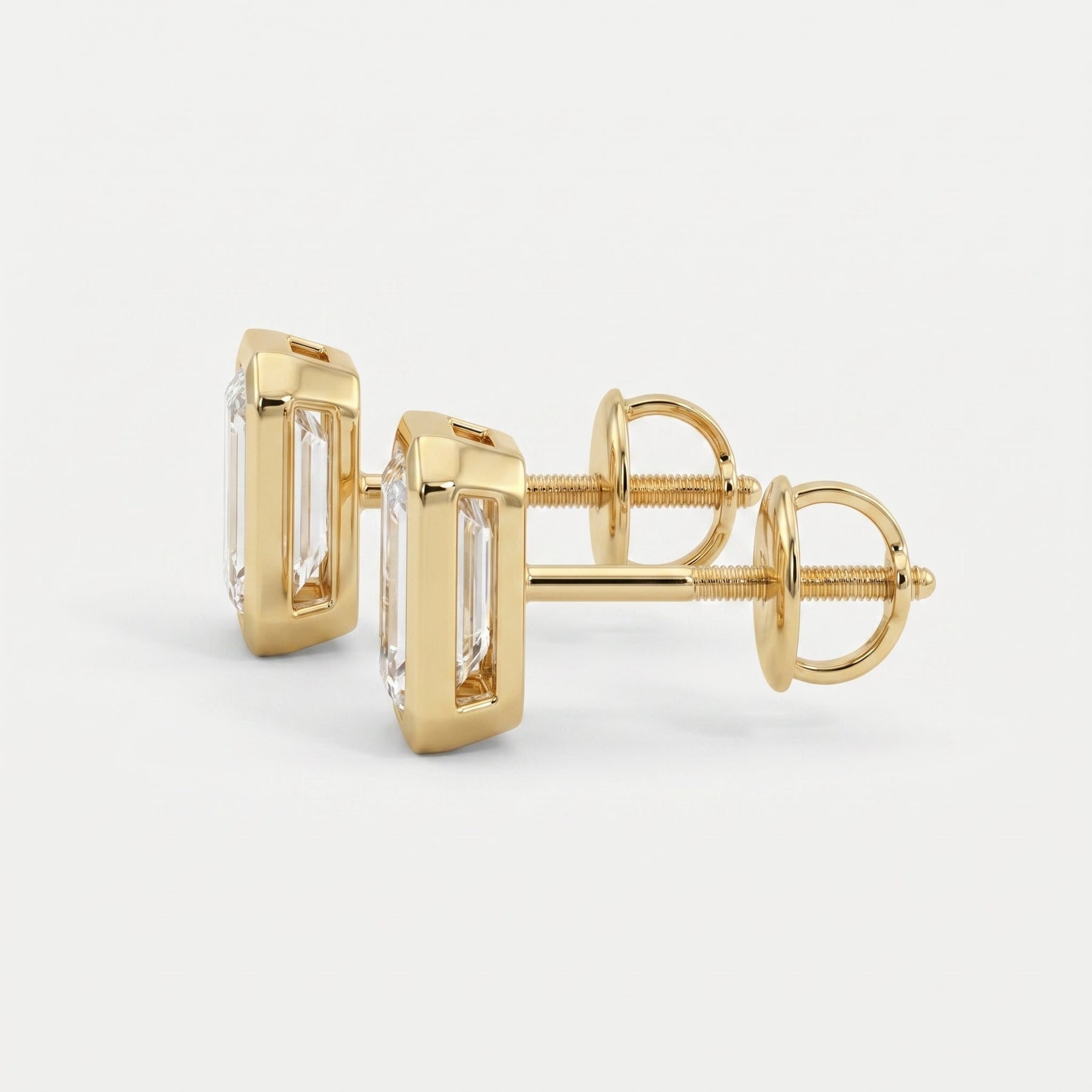Gold earrings with clear gemstones on a white background