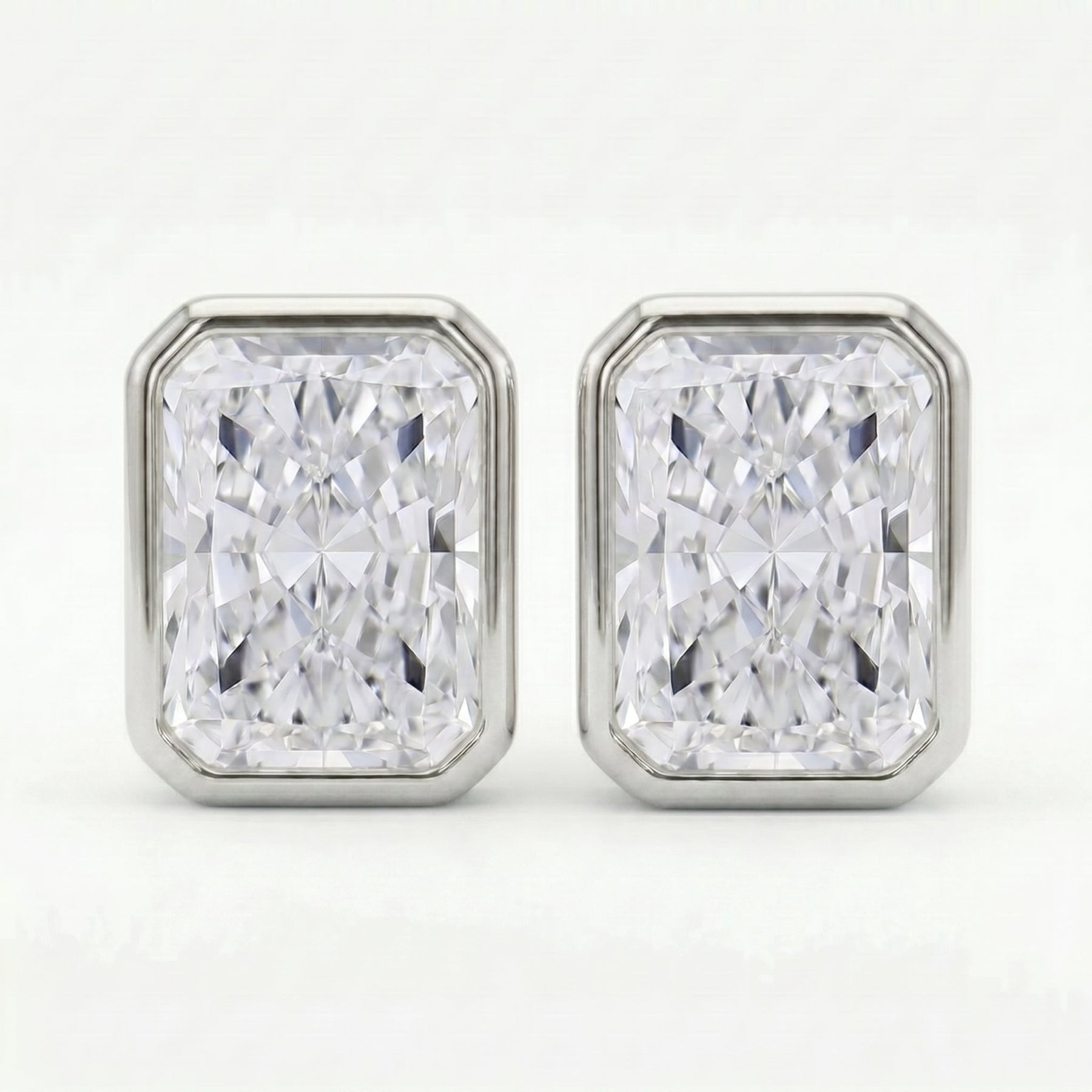 Pair of diamond stud earrings on a white background