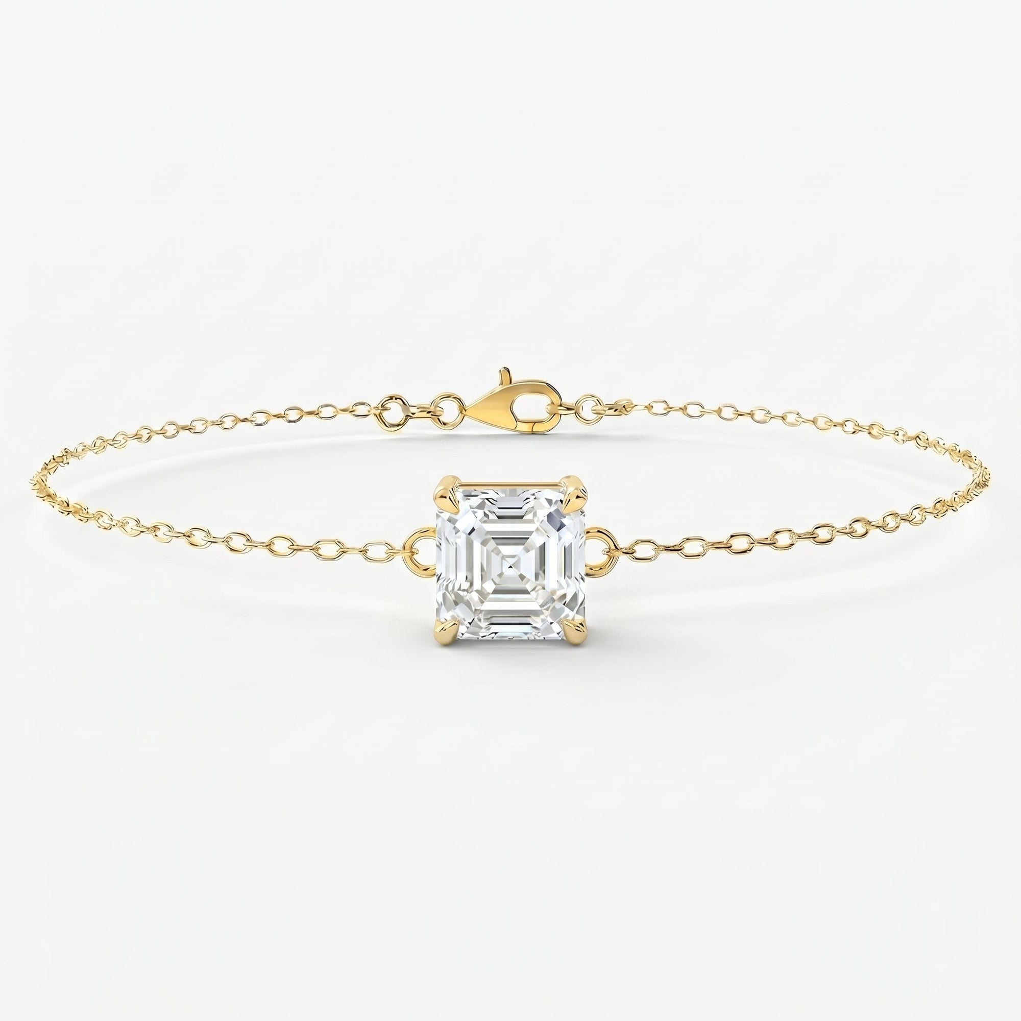 Minimalist yellow gold bracelet with Asscher-cut solitaire gemstone on delicate chain studio front view