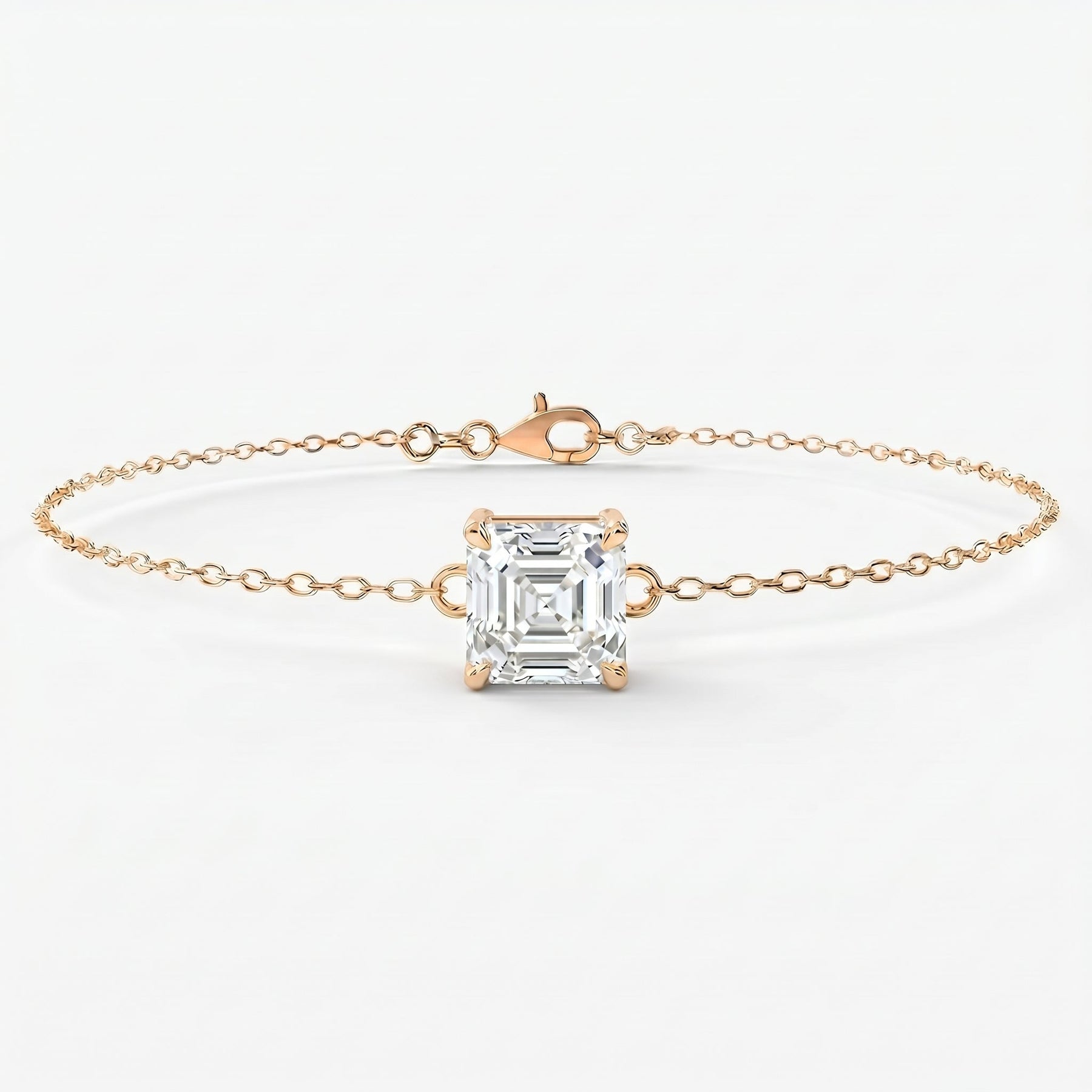 Minimalist asscher cut solitaire bracelet in yellow gold with delicate chain and sparkling diamond centerpiece