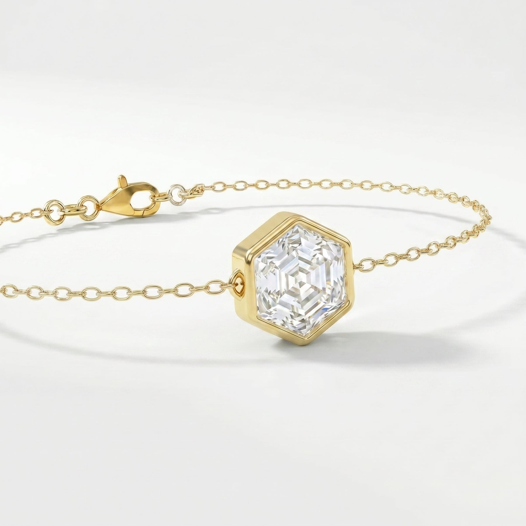 Elegant geometric gold bracelet with hexagon-cut clear stone and fine luxury chain detail