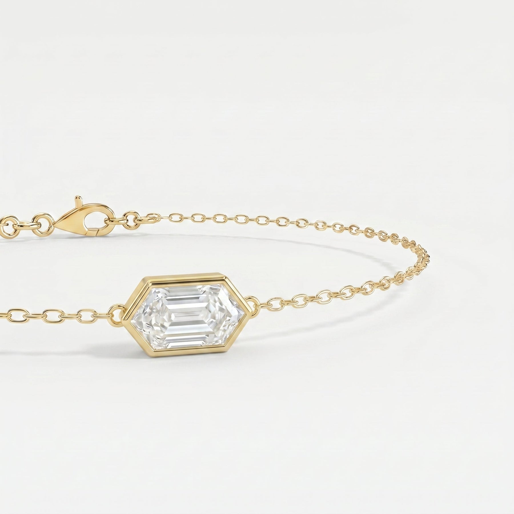 Luxury gold bracelet featuring hexagon-cut diamond style gemstone with delicate chain detail