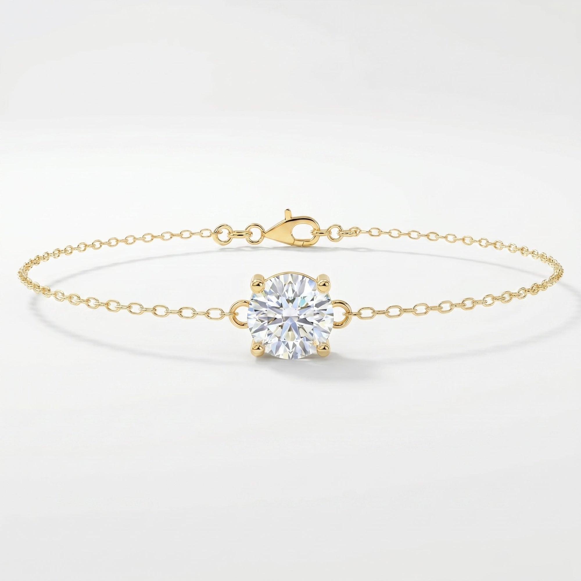 Minimalist yellow gold solitaire chain bracelet with round brilliant stone on clean white background
