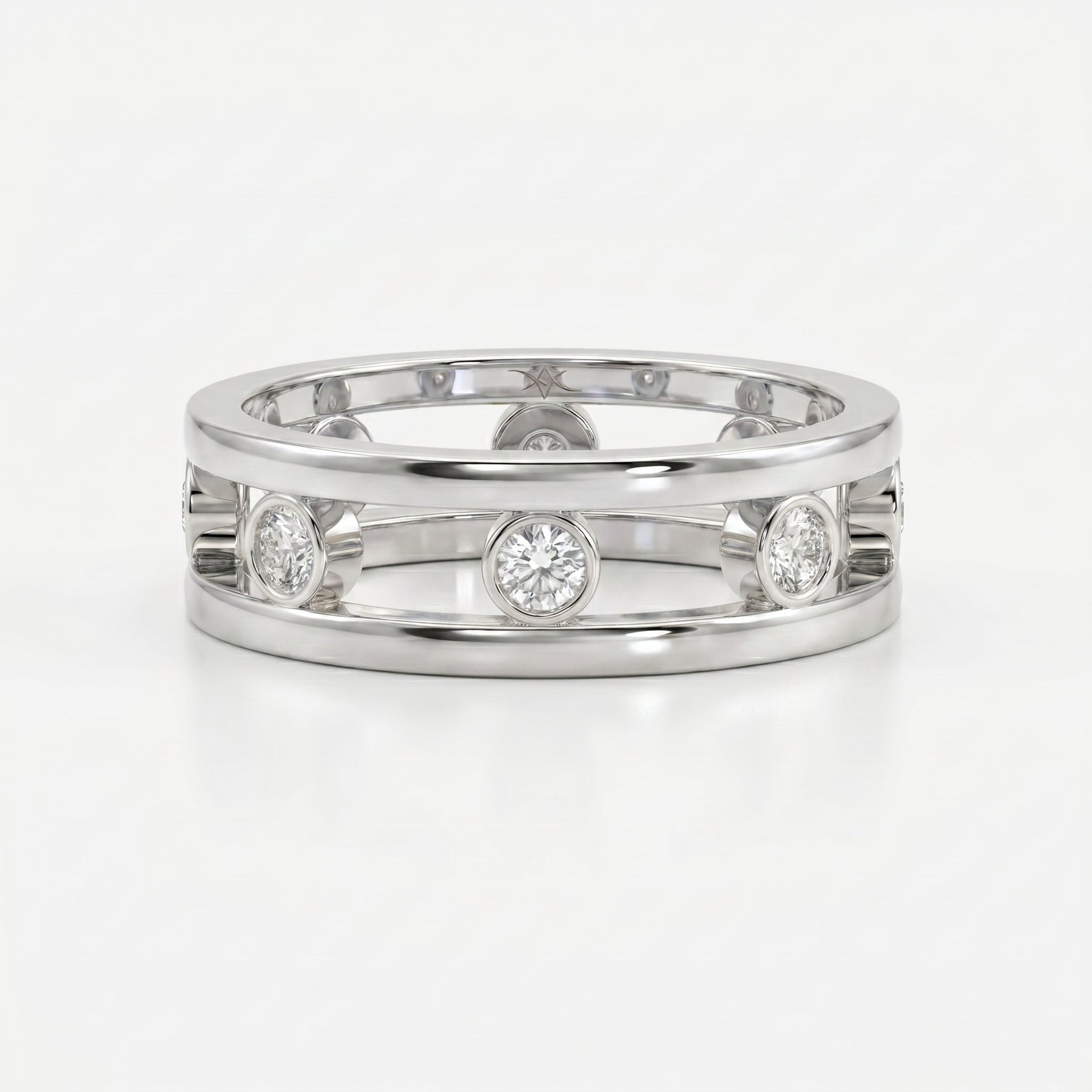 Top view of modern diamond band ring with open structure and bezel set round brilliant diamonds