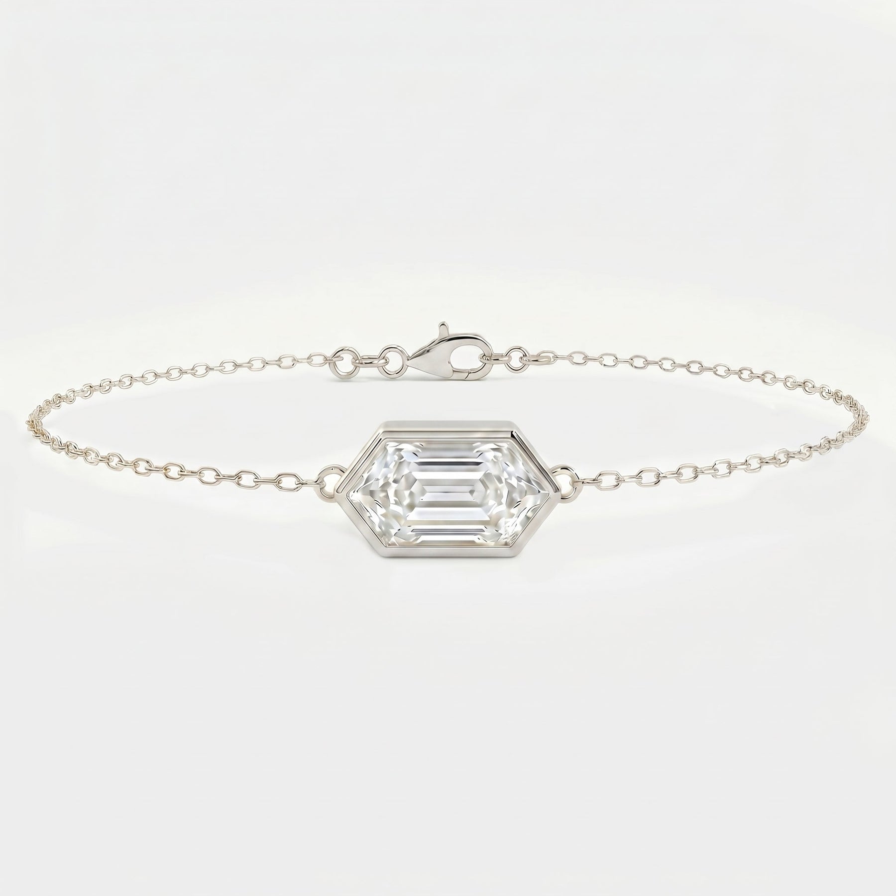 White gold hexagon diamond bracelet with emerald step cut gemstone on delicate minimalist chain