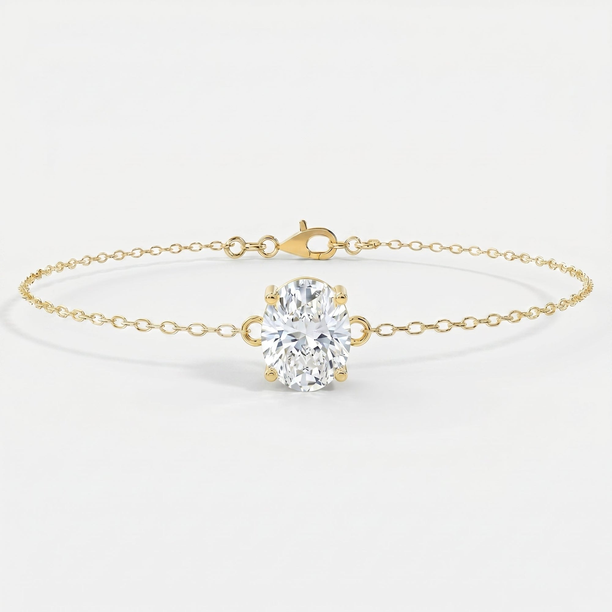 Side profile of oval diamond bracelet showing four-prong yellow gold setting and delicate chain craftsmanship